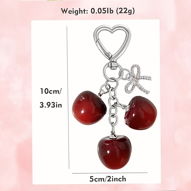 Portachiavi a forma di ciliegia con fiocco e ciondolo a forma di cuore - Resina rossa, finiture dorate - Ideale per borse da donna, portafogli, accessori per San Valentino, ciondolo per borsa a forma di ciliegia