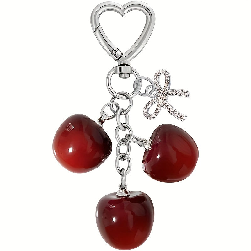 Portachiavi a forma di ciliegia con fiocco e ciondolo a forma di cuore - Resina rossa, finiture dorate - Ideale per borse da donna, portafogli, accessori per San Valentino, ciondolo per borsa a forma di ciliegia