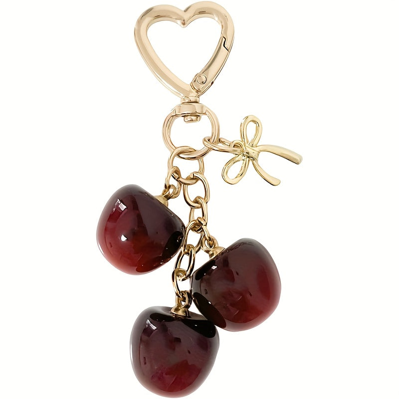 Portachiavi a forma di ciliegia con fiocco e ciondolo a forma di cuore - Resina rossa, finiture dorate - Ideale per borse da donna, portafogli, accessori per San Valentino, ciondolo per borsa a forma di ciliegia