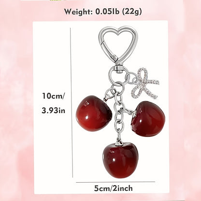 Portachiavi a forma di ciliegia con fiocco e ciondolo a forma di cuore - Resina rossa, finiture dorate - Ideale per borse da donna, portafogli, accessori per San Valentino, ciondolo per borsa a forma di ciliegia