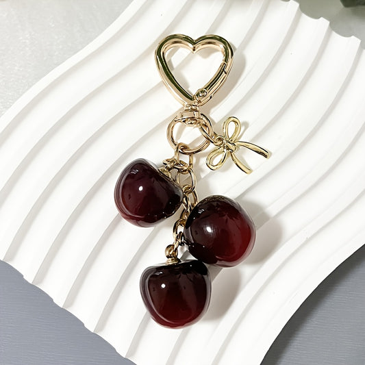 Portachiavi a forma di ciliegia con fiocco e ciondolo a forma di cuore - Resina rossa, finiture dorate - Ideale per borse da donna, portafogli, accessori per San Valentino, ciondolo per borsa a forma di ciliegia